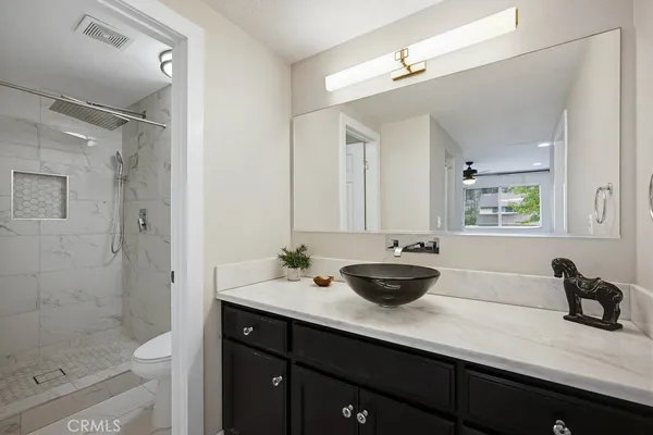 a bathroom with a double vanity sink and mirror with shower