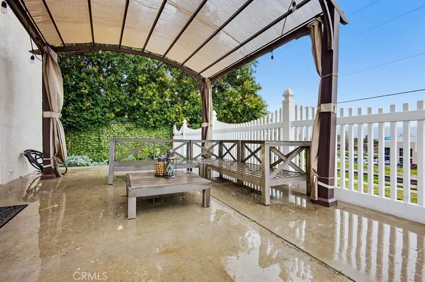 a view of a porch with furniture and a backyard