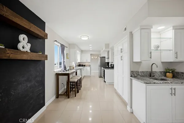 a kitchen with refrigerator and chairs