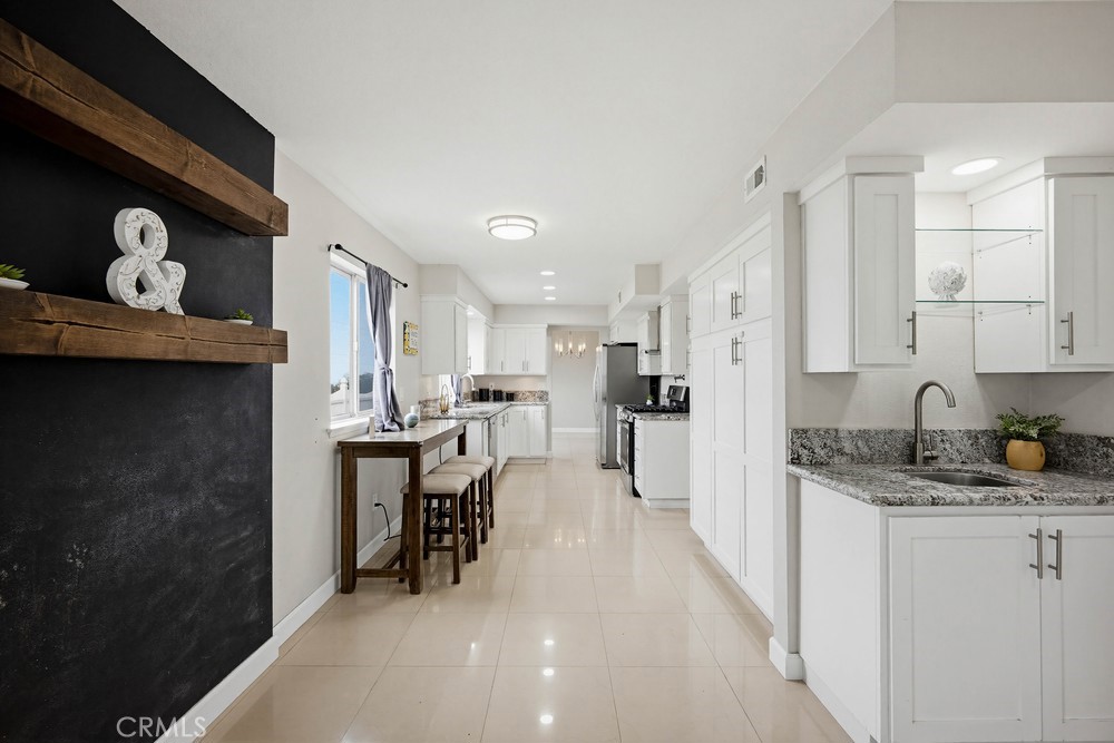 2256 Kentwood Drive Riverside, CA 92507 - Photo 9 of 26 a kitchen with refrigerator and chairs