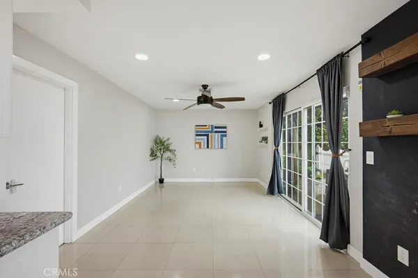 a view of a hallway to a livingroom with furniture