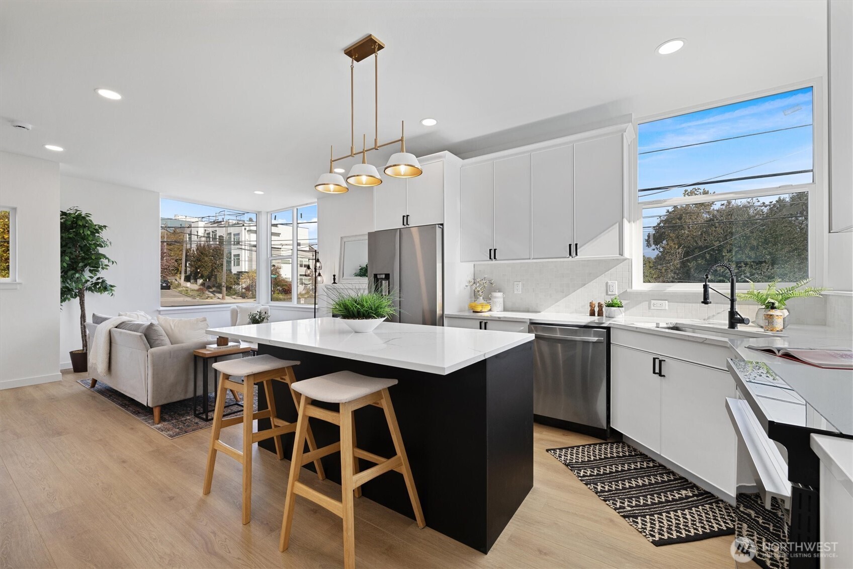 2317 South Judkins Street Seattle, WA 98144 - Photo 6 of 22 a kitchen with stainless steel appliances kitchen island granite countertop a table chairs in it and wooden floors