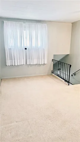a view of an empty room with wooden door