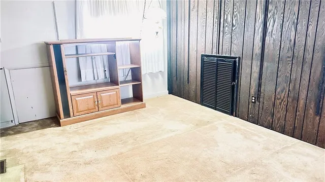 a view of an empty room with wooden walls