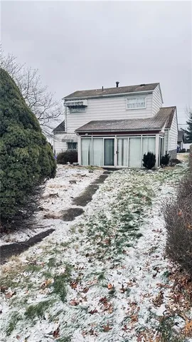 a view of a house with a wooden fence