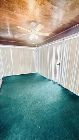 a view of a yard with wooden fence