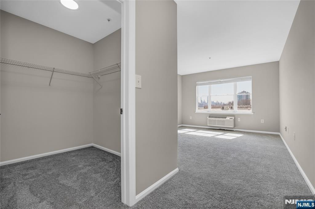 905 River Road, Unit 312 Edgewater, NJ 07020 - Photo 13 of 33 a view of a room with wooden floor and windows