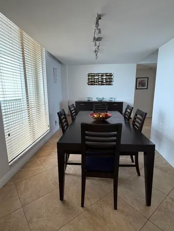 a view of a dining room with furniture and window