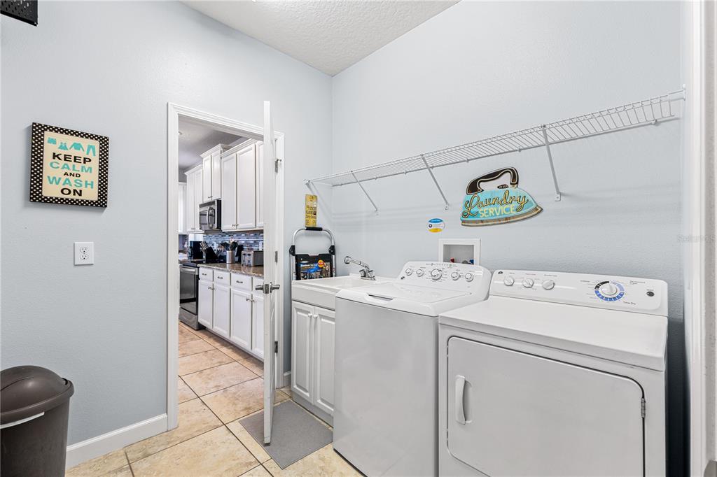 9006 Majesty Palm Road Kissimmee, FL 34747 - Photo 28 of 56 a utility room with dryer and washer