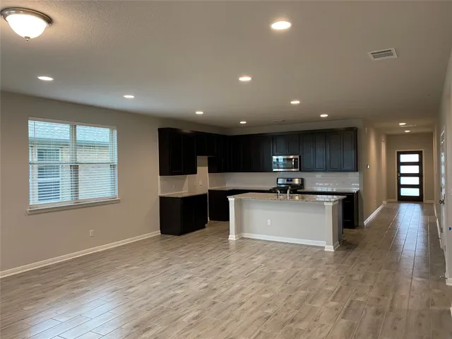 a view of kitchen with a sink wooden floor and kitchen