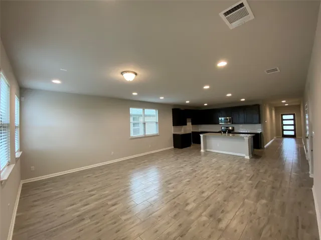 a view of kitchen with kitchen island and wooden floor