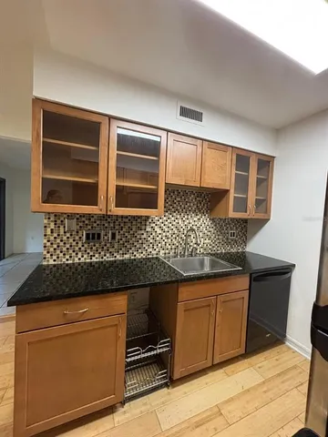 a kitchen with granite countertop stainless steel appliances and wooden cabinets
