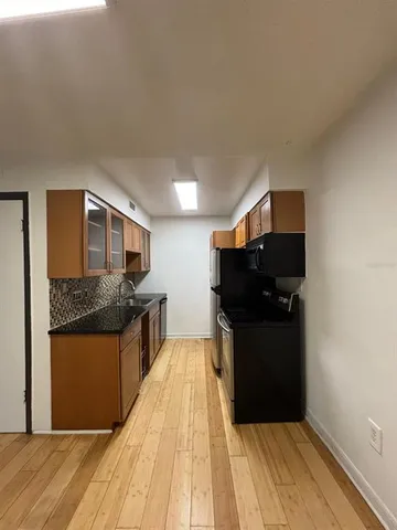 a view of a room with an empty space and a window