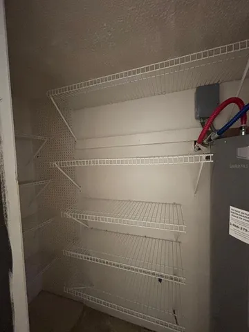 a kitchen with granite countertop a refrigerator and a stove top oven