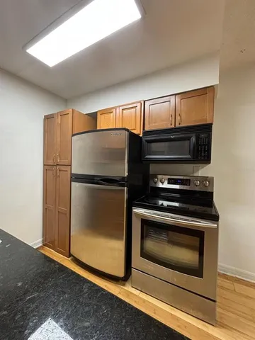 a kitchen with stainless steel appliances granite countertop a stove and a sink