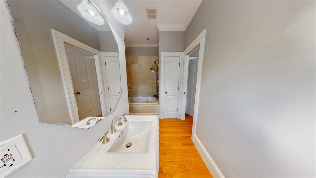 30-32 Ward Street, Unit 2 Boston, MA 02127 - Photo 13 of 14 a spacious bathroom with a tub shower and sink