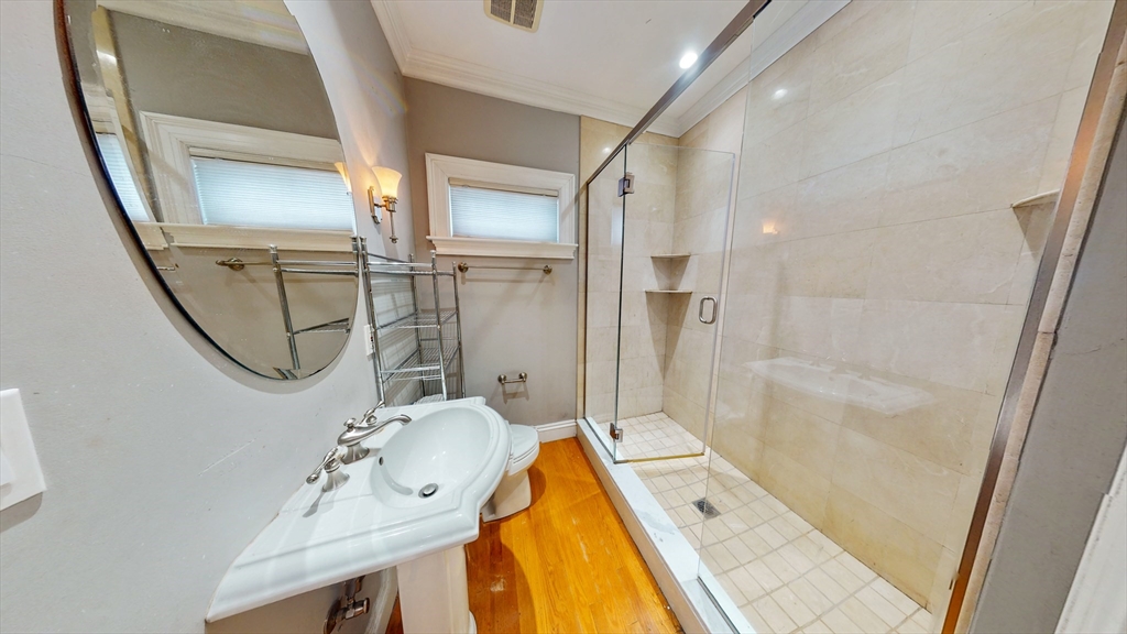 30-32 Ward Street, Unit 2 Boston, MA 02127 - Photo 14 of 14 a bathroom with a granite countertop sink a mirror and shower