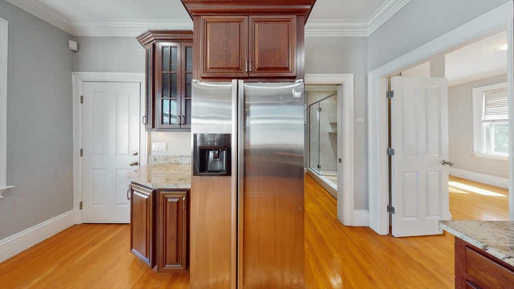 30-32 Ward Street, Unit 2 Boston, MA 02127 - Photo 2 of 14 a kitchen with stainless steel appliances granite countertop a refrigerator and a stove