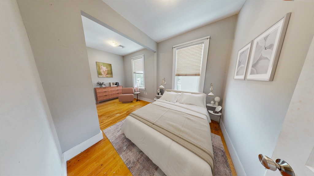 30-32 Ward Street, Unit 2 Boston, MA 02127 - Photo 4 of 14 a spacious bedroom with a bed and a window