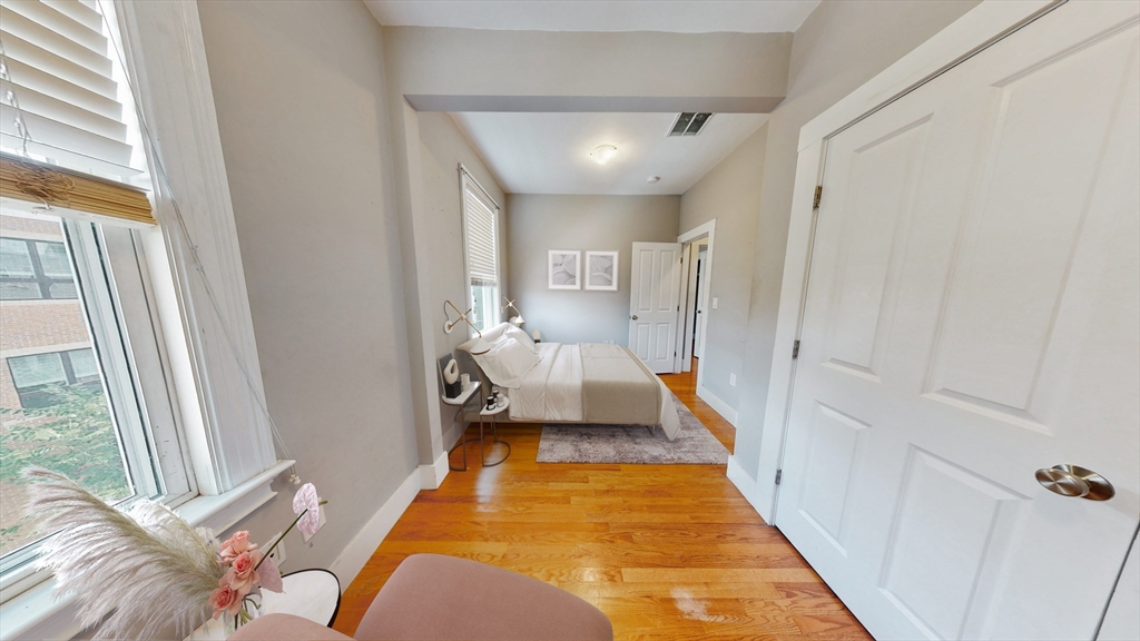 30-32 Ward Street, Unit 2 Boston, MA 02127 - Photo 5 of 14 a spacious bedroom with a bed and a window