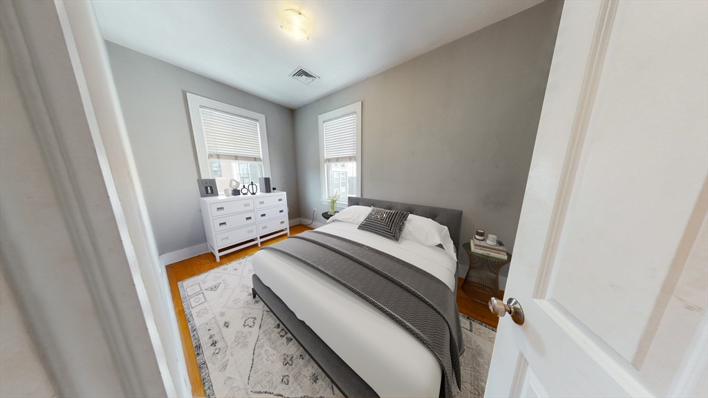 30-32 Ward Street, Unit 2 Boston, MA 02127 - Photo 6 of 14 a bedroom with a bed and a window