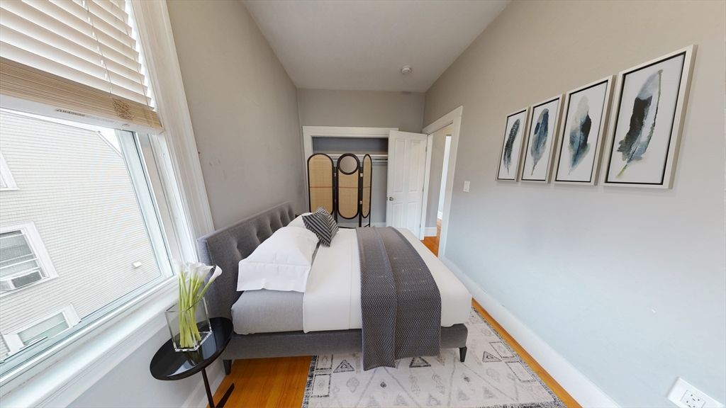 30-32 Ward Street, Unit 2 Boston, MA 02127 - Photo 7 of 14 a bedroom with bed and wooden floor