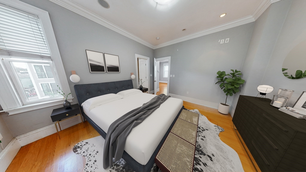 30-32 Ward Street, Unit 2 Boston, MA 02127 - Photo 9 of 14 a bedroom with a bed and wooden floor