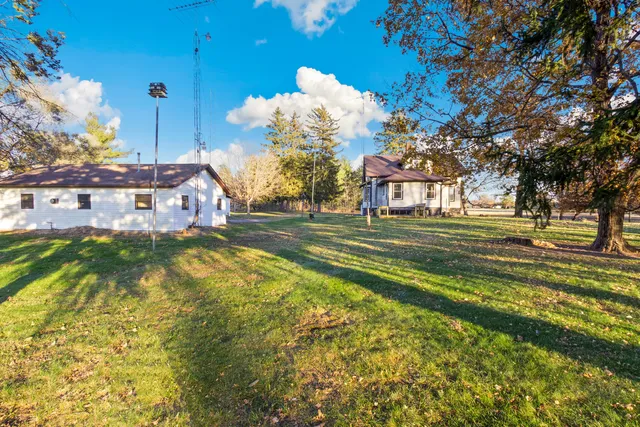 a swimming pool with outdoor seating and yard