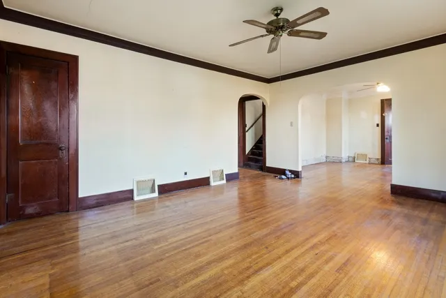 a view of a livingroom with a hardwood floor and a ceiling fan