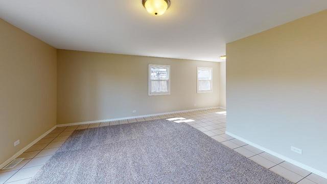 184 North Pinecrest Road Bolingbrook, IL 60440 - Photo 14 of 24 a view of an empty room with window and wooden floor