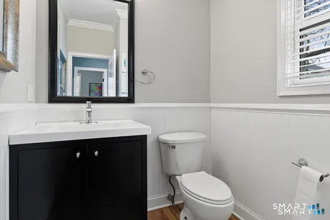 a bathroom with a sink toilet and a mirror