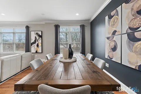 a view of a dining room with furniture window and wooden floor