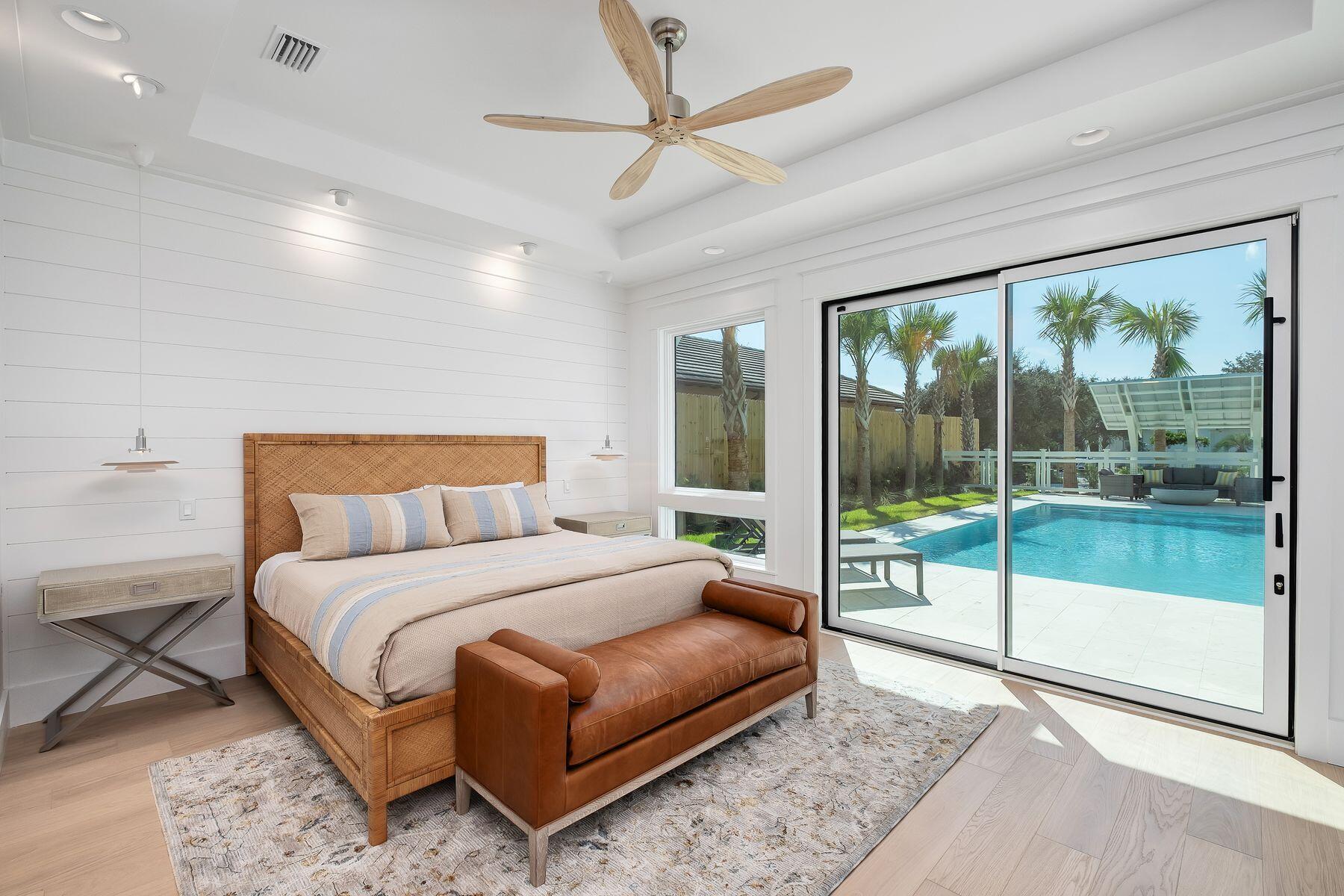 56 Pelican Glide Lane Seacrest, FL 32461 - Photo 16 of 55 a bedroom with a large bed and a large window