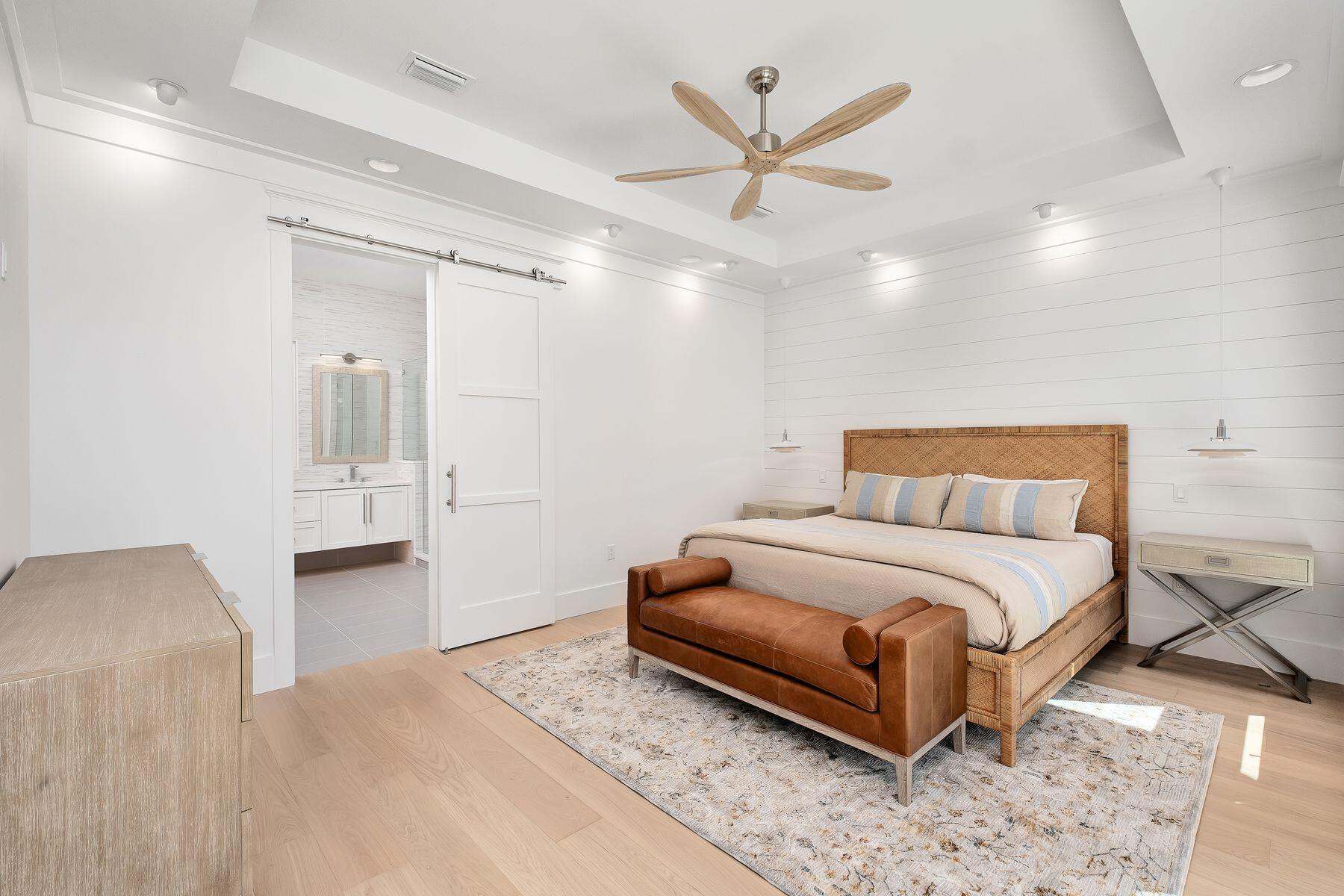 56 Pelican Glide Lane Seacrest, FL 32461 - Photo 17 of 55 a spacious bedroom with a bed and a chandelier