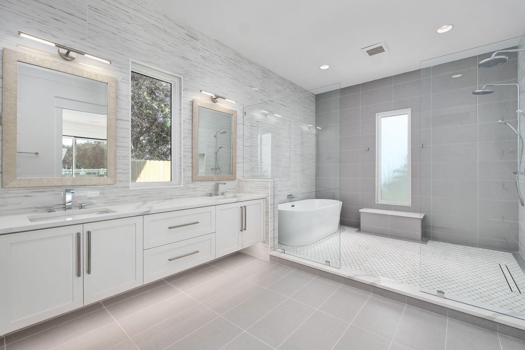 56 Pelican Glide Lane Seacrest, FL 32461 - Photo 18 of 55 a bathroom with double vanity sink a two mirror a window a bathtub and vanity