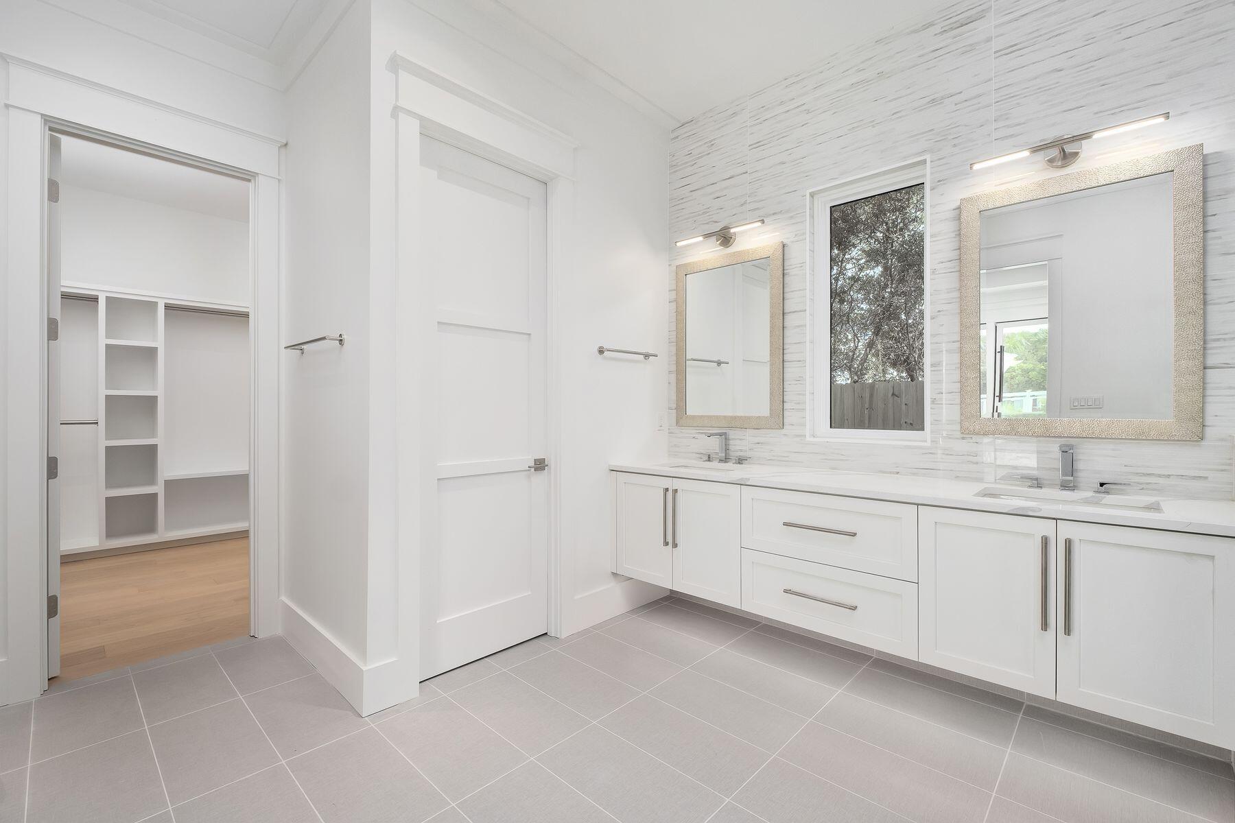 56 Pelican Glide Lane Seacrest, FL 32461 - Photo 20 of 55 a spacious bathroom with a double vanity sink a mirror and a bathtub