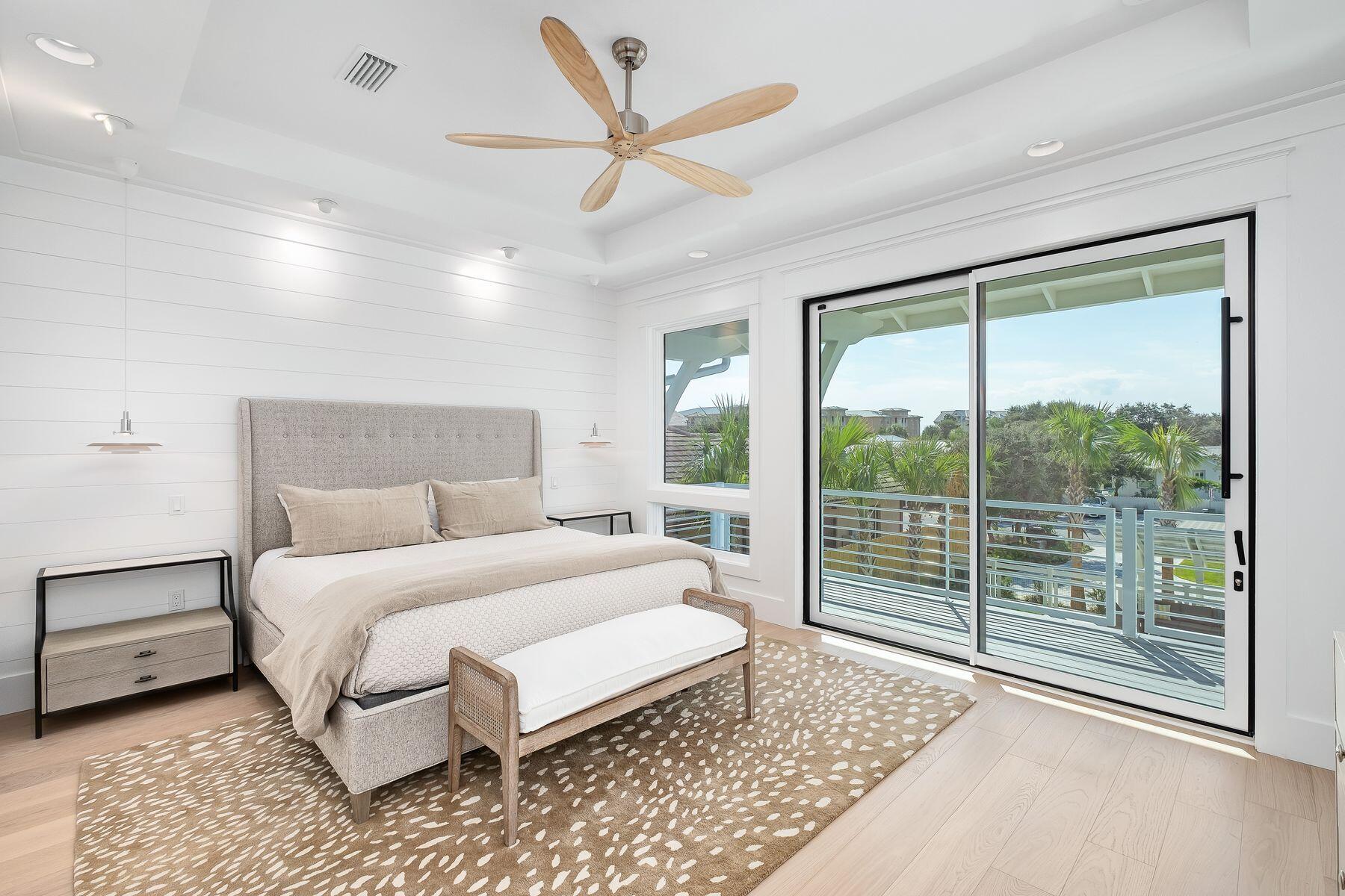 56 Pelican Glide Lane Seacrest, FL 32461 - Photo 22 of 55 a bedroom with a large bed and a large window