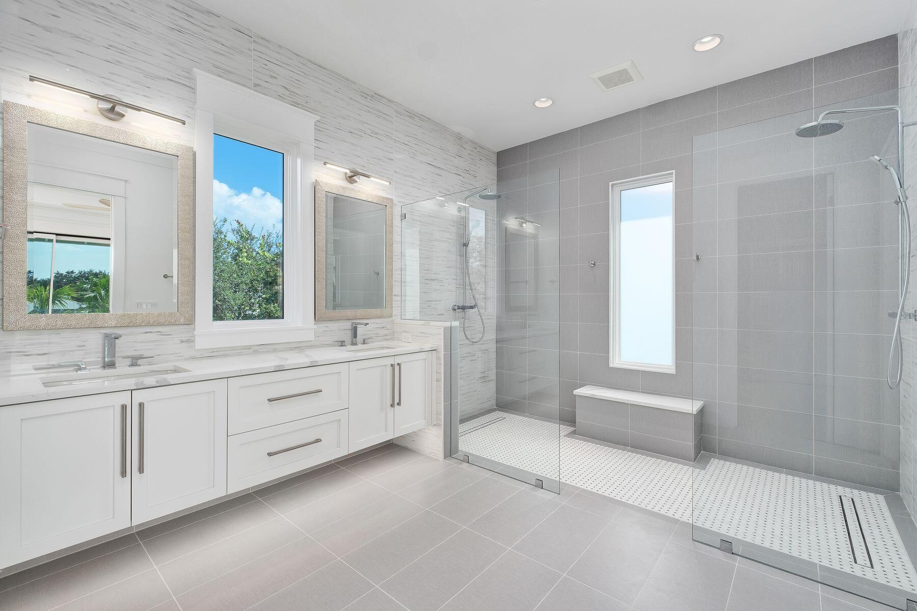 56 Pelican Glide Lane Seacrest, FL 32461 - Photo 25 of 55 a spacious bathroom with a mirror a sink and a shower