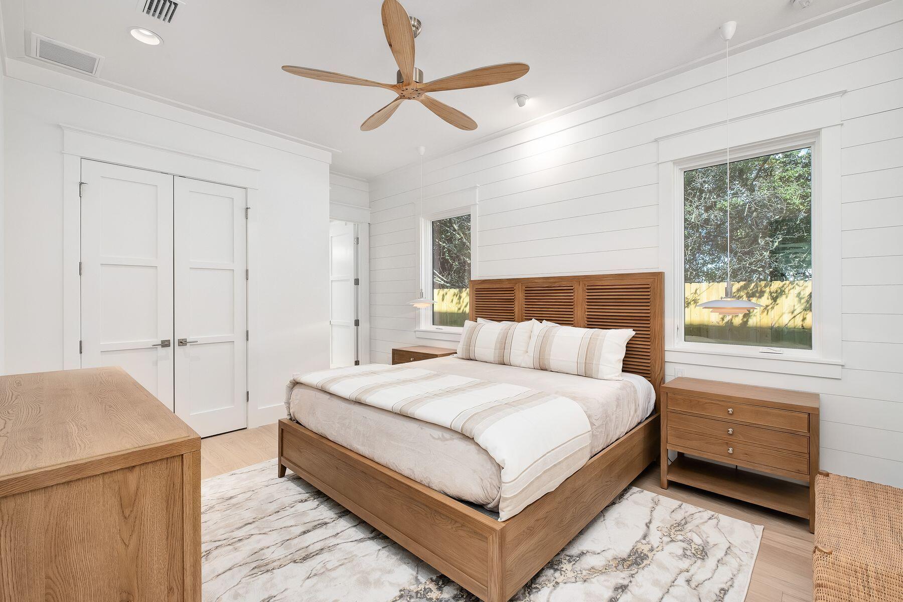 56 Pelican Glide Lane Seacrest, FL 32461 - Photo 28 of 55 a bedroom with a large bed and a chandelier