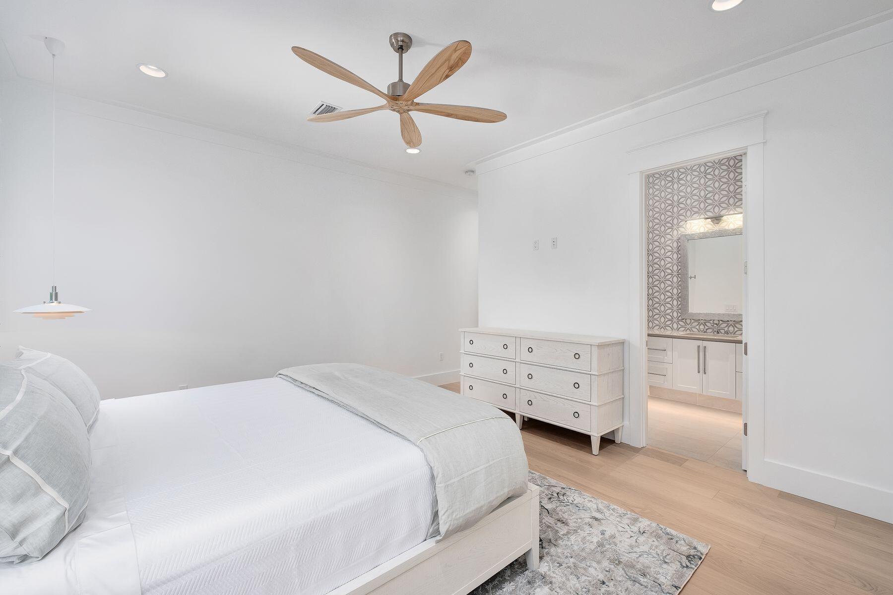 56 Pelican Glide Lane Seacrest, FL 32461 - Photo 35 of 55 a bedroom with a bed and a chandelier