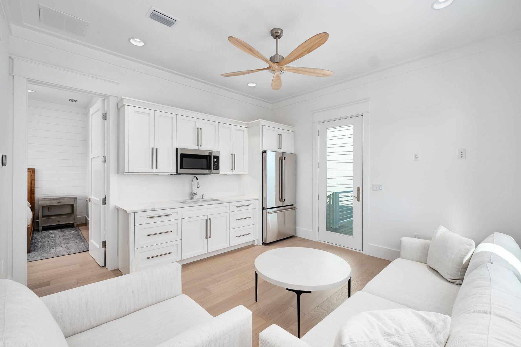 56 Pelican Glide Lane Seacrest, FL 32461 - Photo 43 of 55 a living room with furniture a window and a ceiling fan