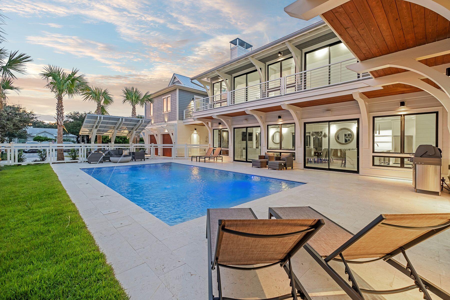 56 Pelican Glide Lane Seacrest, FL 32461 - Photo 50 of 55 a swimming pool with outdoor seating and yard