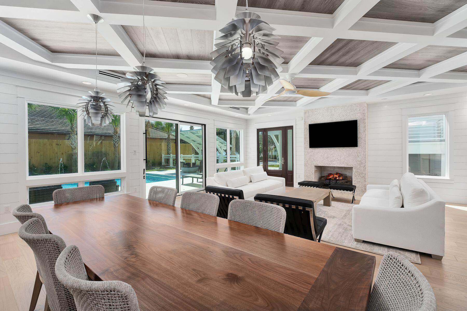 56 Pelican Glide Lane Seacrest, FL 32461 - Photo 9 of 55 a living room with patio furniture and a chandelier