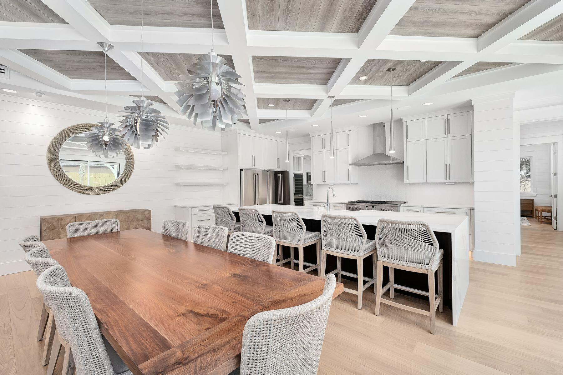 56 Pelican Glide Lane Seacrest, FL 32461 - Photo 10 of 55 a dining room with wooden floor a chandelier a wooden table and chairs