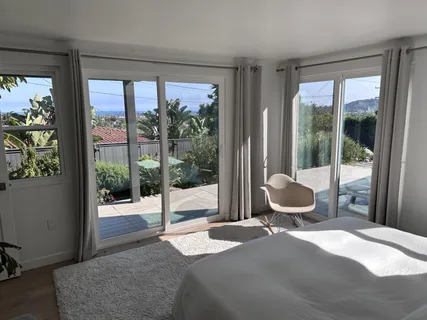 a bedroom with a bed and glass door