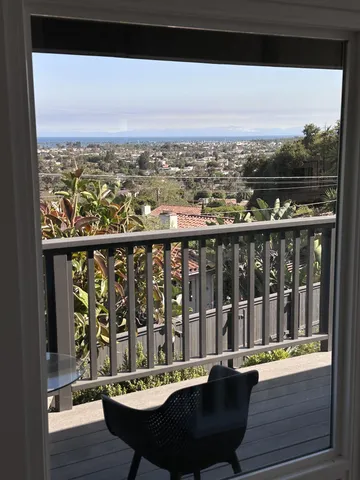 a view of a balcony with wooden floor and city view