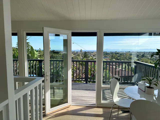a view of a balcony with chairs