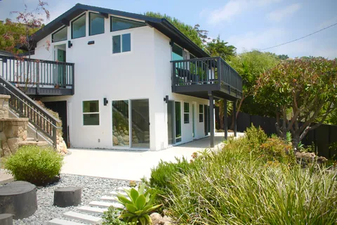 a front view of a house with a garden