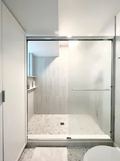 a bathroom with a bathtub and a shower