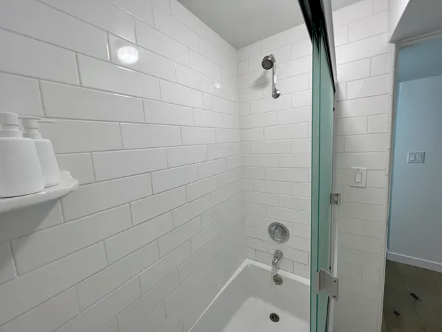 a bathroom with a bathtub and shower
